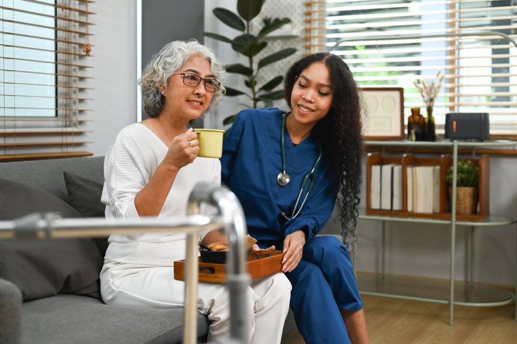 Image of a personal support worker (PSW) taking care of elderly woman during home care visit.