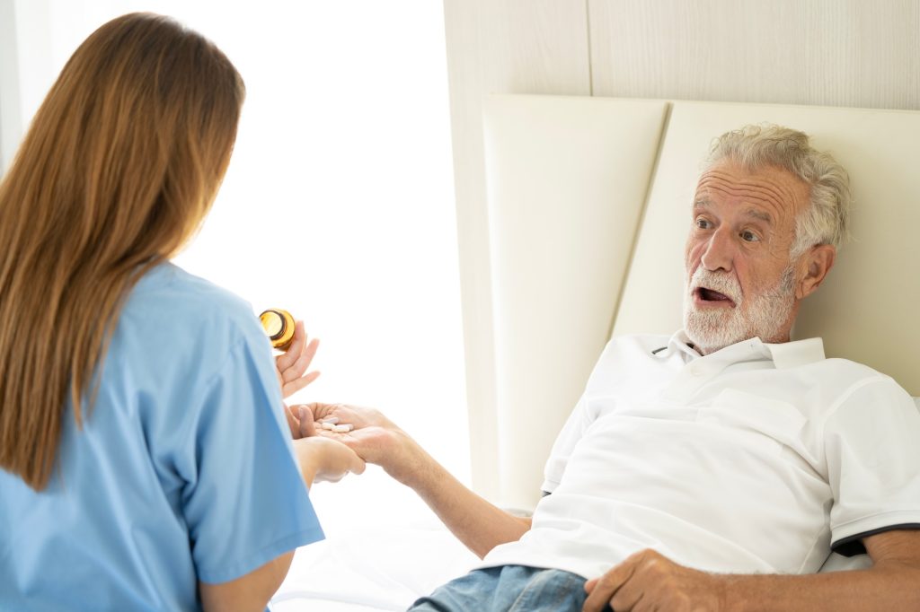 Man being cared for by a private personal support worker PSW nurse at home in Hamilton, Ontario