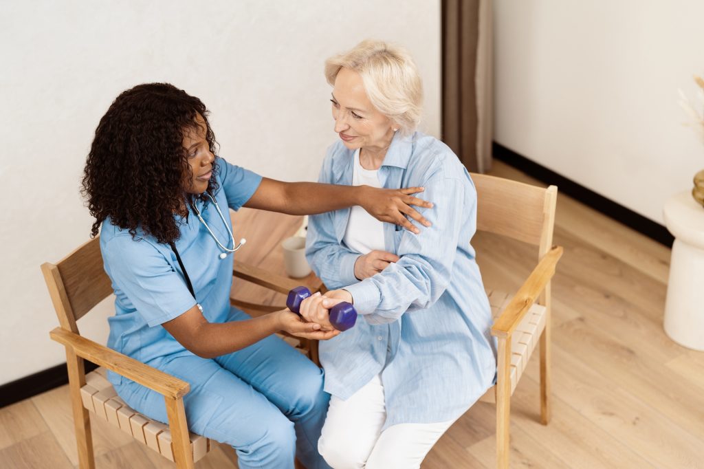 Private Personal support worker PSW Assisting Elderly Woman with Physical Therapy Exercises at Home