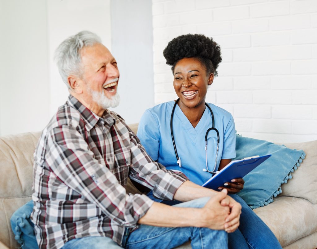 African nurse offering dementia care to an old man in Hamilton, Ontario