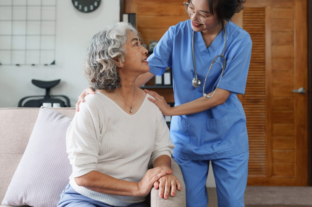 Asian home health care nurse in Edmonton, AB caring for patients or the elderly at home. nursing at home concept